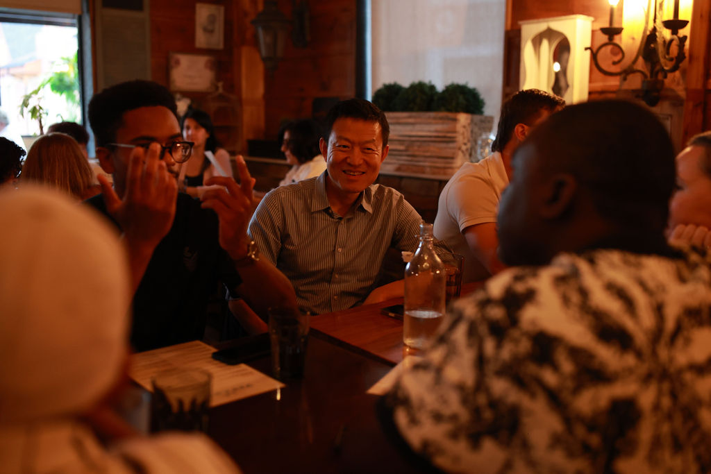 Guests talking and laughing around the table at a JN Network business networking event in Toronto
