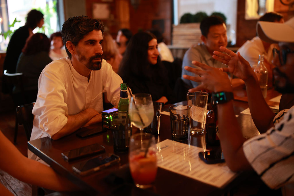 A full table of professionals connecting at a JN Network event in Toronto